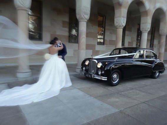 Black wedding car with chauffeur